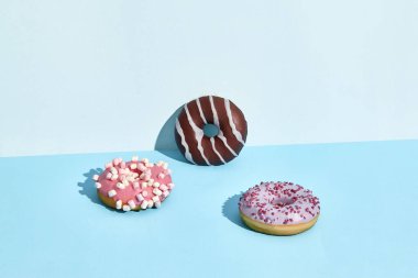 Three Colorful donuts on a blue background donut