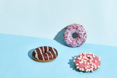 Three Colorful donuts on a blue background donut