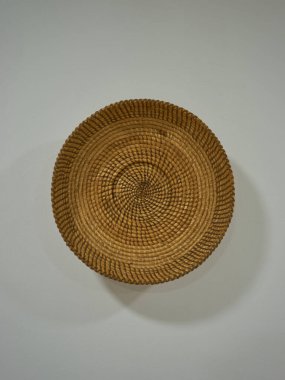 Beyaz bir duvarda eski bir esparto şapkası 