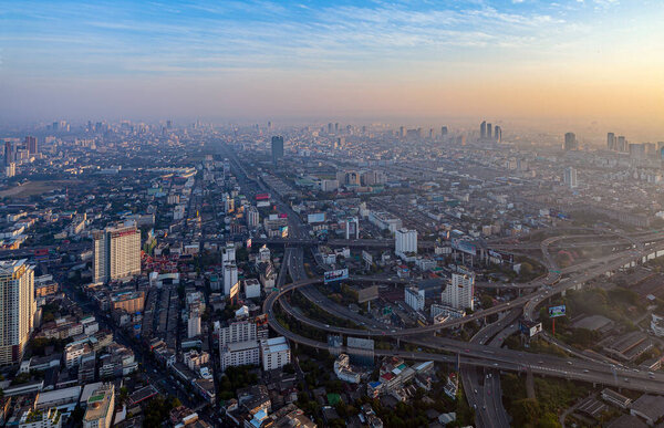 Dawn over Bangkok. At the height of a bird's flight. Smog hell city