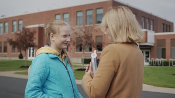 Studerande pratar med lärare utanför skolan — Stockvideo