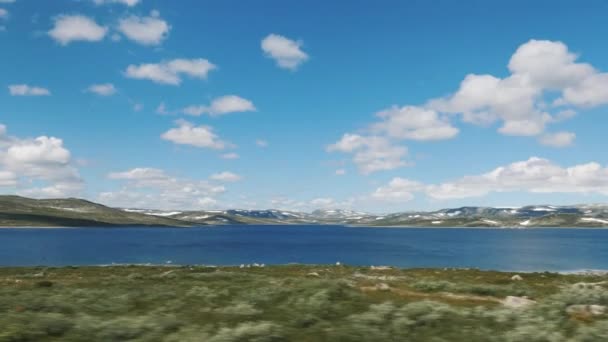 View from the window of the car on the tundra and lake. The nature of Scandinavia — Vídeos de Stock