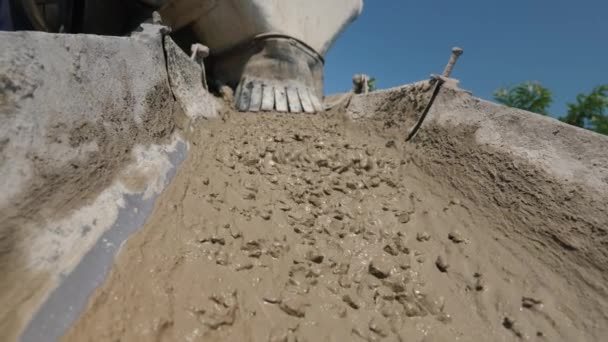 Uma poderosa corrente de concreto flui do concreto através da calha. Obras de betão no estaleiro — Vídeo de Stock