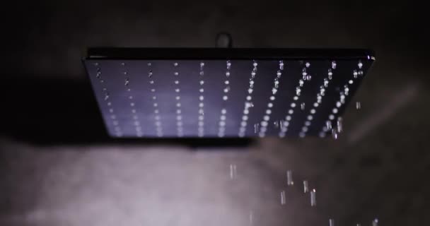 Water flows from a black square nozzle in the shower — Stock Video