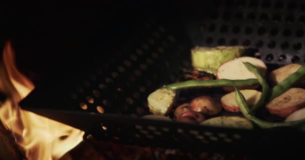 Delicious potatoes with vegetables are fried on an open fire — Video Stock