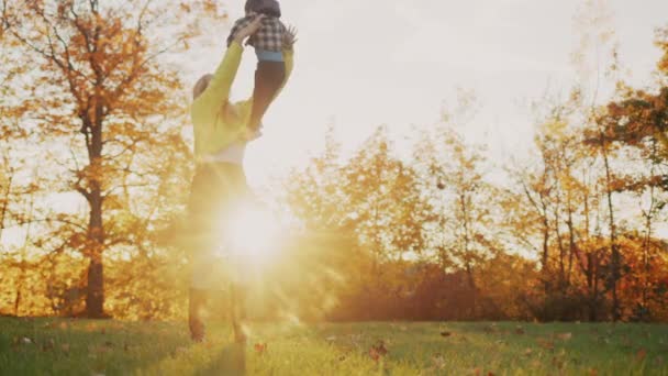 Mother Plays Child Tosses Catches Sunset Beautiful Autumn Park — Vídeo de Stock