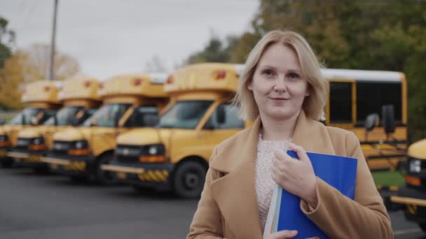 Portrait Middle Aged Teacher Stands Background Row Yellow School Buses — Video