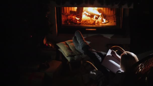 Woman Writes Notebook While Sitting Fireplace — Vídeo de Stock