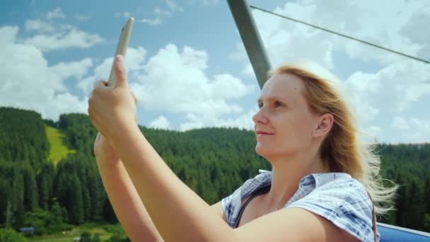 Active Woman Cabin Ski Lift Photographs Beautiful Views Mountains Forests — Stockvideo