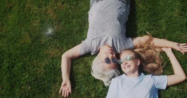 Grandmother Granddaughter Lie Grass Jets Water Laugh Escape Heat — Stockvideo