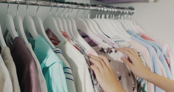 Hands Child Chooses Dress Coat Hanger Wardrobe — Vídeo de Stock