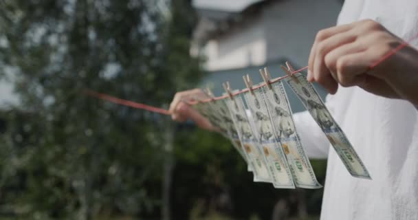 Man Holds Clothesline His Hands Which Banknotes Hang Money Laundering — 图库视频影像