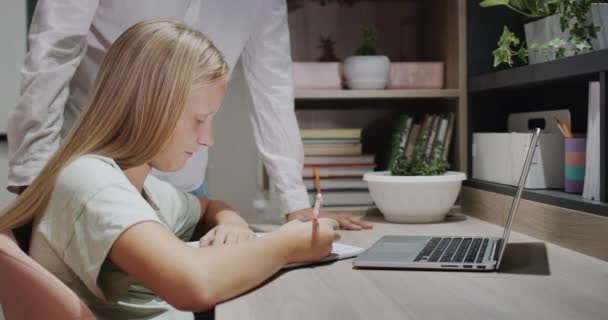 Older Brother Helps His Sister Homework Cat Sitting Next Him — стоковое видео