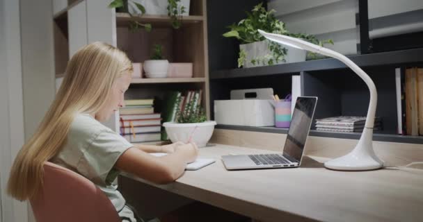 Child Beautiful Long Hair Does Homework Home Sits Table Laptop — Stockvideo