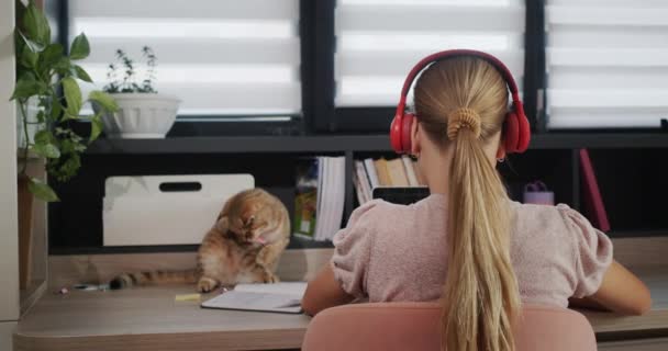 Teenage Girl Studying Laptop Home She Has Headphones Her Pet — 图库视频影像