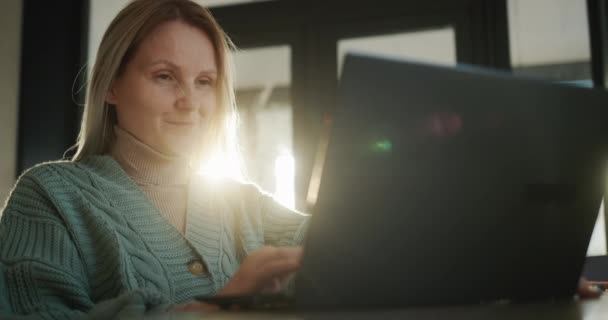 Mujer Mediana Edad Usando Ordenador Portátil Sol Ventana Ilumina — Vídeo de stock