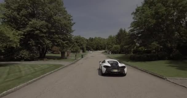 Aerial White Mclaren Supercar Driving Neighborhood — Stock Video