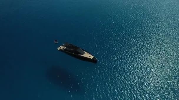Black luxury yacht off the coast of Formentera, recorded with a drone. — Stock Video