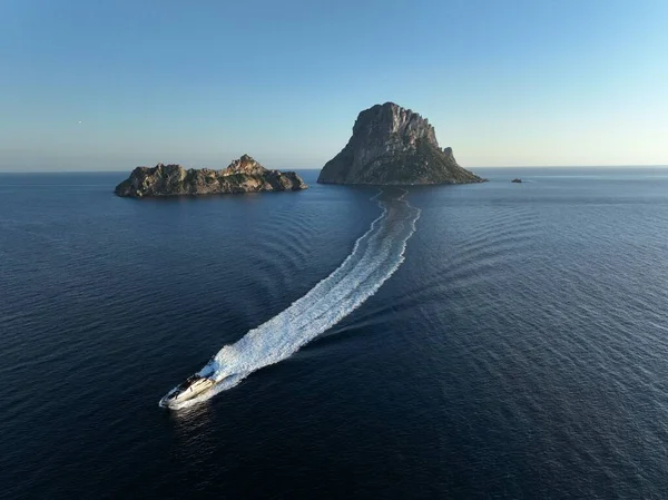 Es Vedra 'nın hava manzarası ve denizde yüzen bir yat. İbiza.