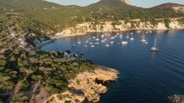 Aerial video beach at sunset. Boats and yachts at anchor. Drone footage.