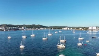 Island coast full of boats and sailboats anchored off the coast. Idyllic place for vacation. Sant Antoni, Ibiza.