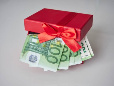 Avrupa para birimiyle dolu kırmızı bir hediye kutusu. 100 Euro 'luk nominal değeri olan banknotlar.
