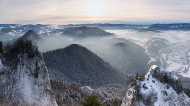 Panoramic view of the Pieniny Mountains. A beautiful winter landscape seen from the Okraglica peak. Frosty and misty morning in the mountains.