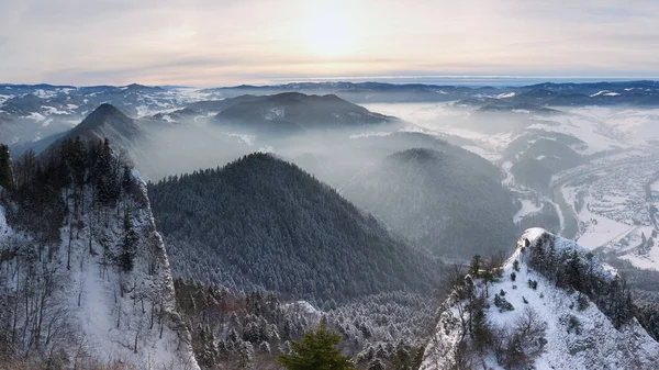 Panoramic view of the Pieniny Mountains. A beautiful winter landscape seen from the Okraglica peak. Frosty and misty morning in the mountains.