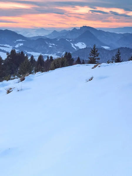 Sunset over the Pieniny Mountains as seen from the top of Wysoki Wierch. Beautiful winter landscape of Polish mountains.