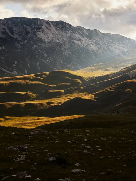 The slopes of the Durmitor mountains lit by the golden rays of the setting sun. Durmitor National Park in Montenegro