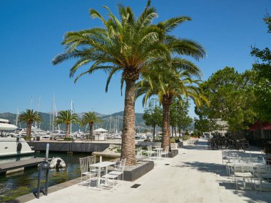 Tivat, Montenegro, July 16, 2022: Beach promenade at the luxury yacht marina Porto Montenegro