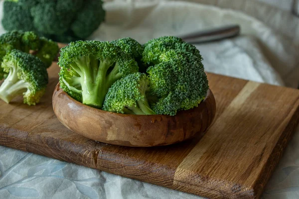 broccoli on a wooden plate, pieces of broccoli close-up