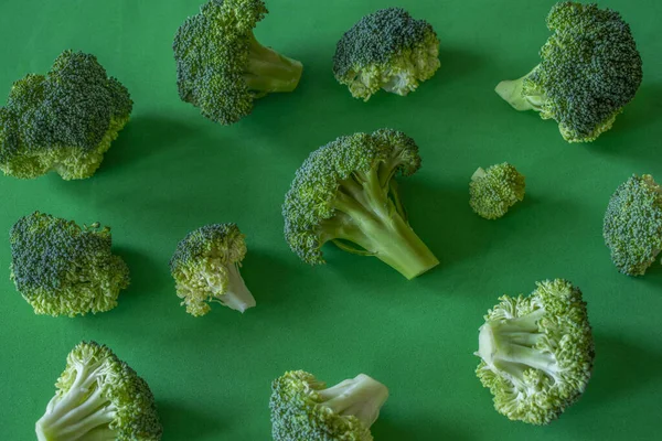 pieces of broccoli on a green background,background,top view