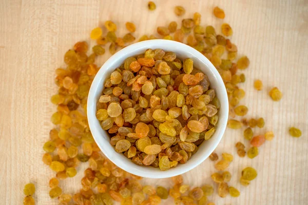 raisins in a white plate, top view,light background