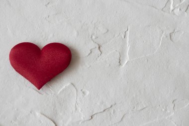 red heart located on the left on a light background