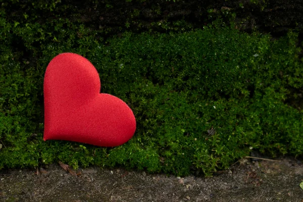red heart located on the green grass outdoors