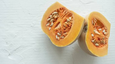 balkabağı yarıları sağda hafif bir arkaplan üzerinde, kopyalama için boşluk, estetik ekran koruyucu