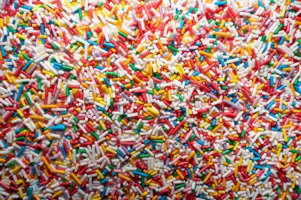 Dekorasyon Arka Planı Olarak Bir Sürü Uzun Renkli Şeker Serpintisi — Stok fotoğraf