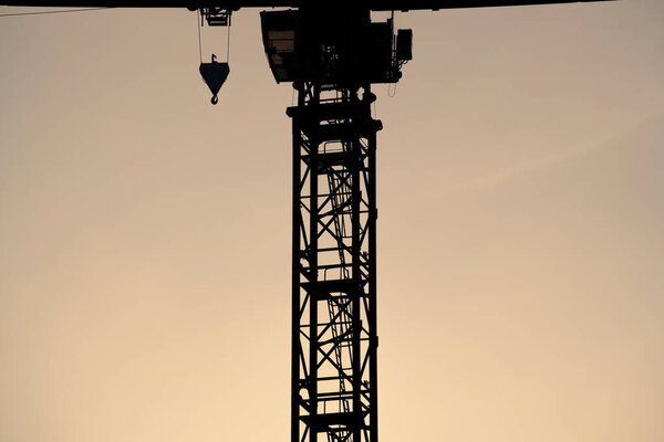 Crane with hook in the sky during the sunset