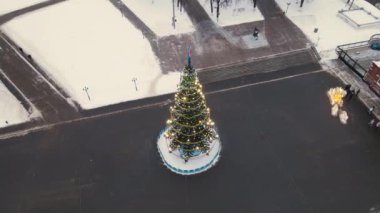 Şehir meydanında uzun, ince bir Noel ağacı, hava manzaralı..