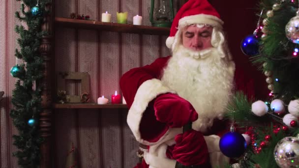 Κοντινό πλάνο χαρούμενα Άγιος Βασίλης ανοίγει ένα μπουκάλι σαμπάνια και συγχαίρει. — Αρχείο Βίντεο