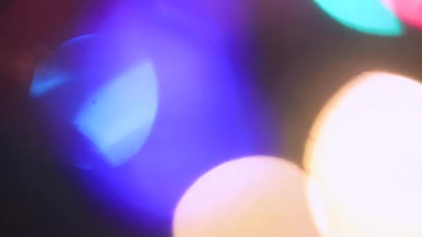 Out of focus, colored Christmas lights mysteriously burn and twinkle. — Stock Video
