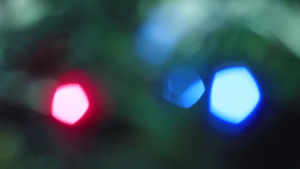 Christmas multicolored lights flicker slowly out of focus. — Stock Video