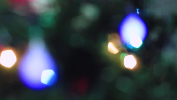 Blurred Christmas eye-catching multicolored lights are burning brightly. — Stock Video