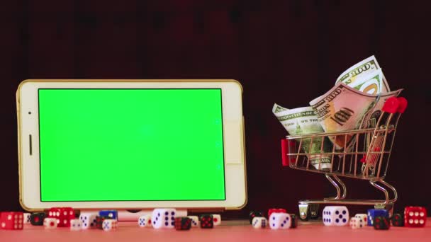 New Years video screensaver cart of dollars and a tablet with a green screen. — Stockvideo