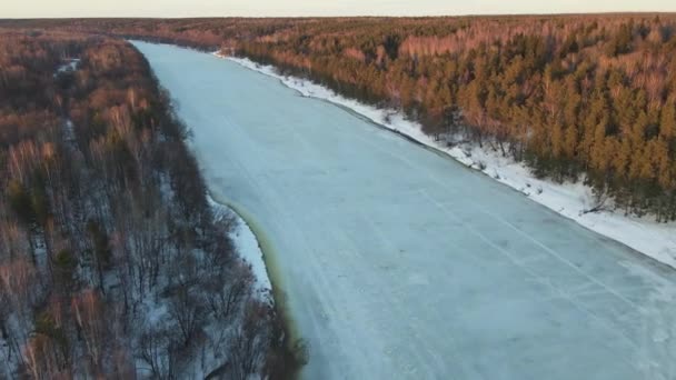 Spectacular winter landscape with frozen river at sunset, aerial view. — Stock Video