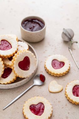 Linzer cookies in shape of heart with jam on light background. Mother's day, Women's day, Valentine's day. Homemade present. Selective focus.