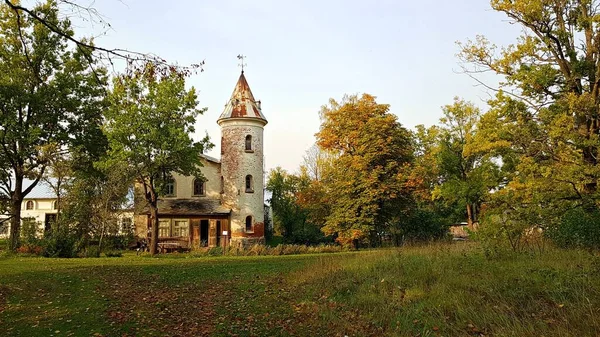 Small old house with a round tower in the Latvian village of Jaungulbene on October 2, 2020.