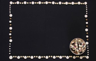 Dikdörtgen çerçeve siyah engelli beyaz haplardan oluşur..