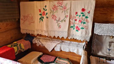 Old cloth tablecloths and napkins trimmed with colorful flowers and handmade patterns.